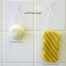 pureSOL Original Konjac Facial Sponge and Turmeric Konjac Cleansing Sponge hanging on included hook (dry)